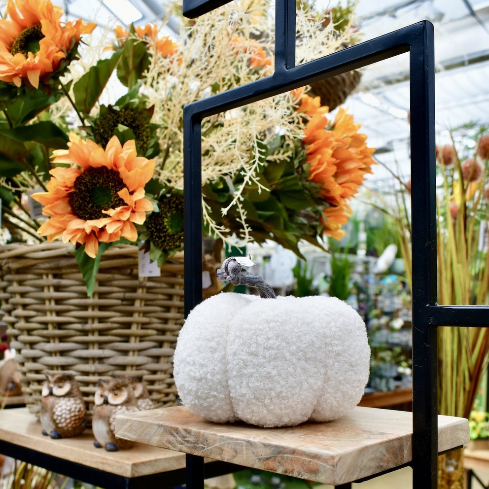 Stoffkürbis vor Sonnenblumen